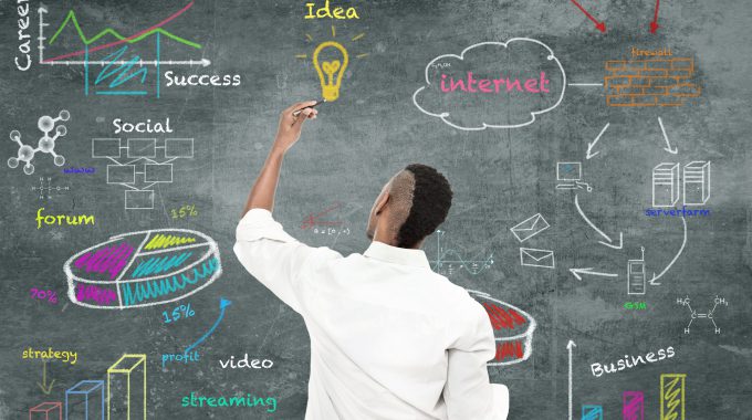 Photo Of Afro Amercian Man Drawing A Strategy Diagram On The Wall