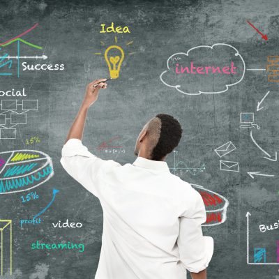 Strategy Diagram photo of afro amercian man drawing a strategy diagram on the wall